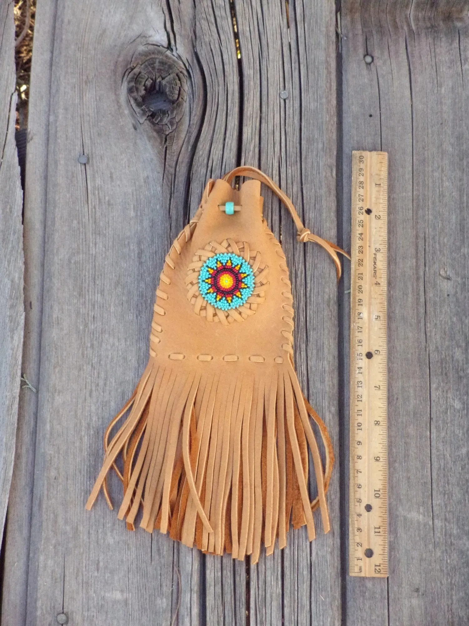 Fringed leather amulet bag, sunflower beadwork